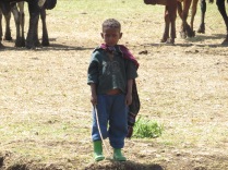 A young herder looking like Superman in his cape